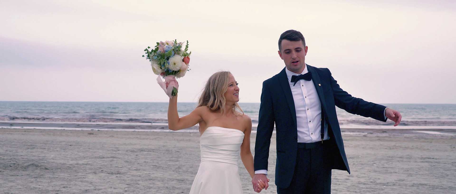 Bride and groom on a New England beach at golden hour, filmed by Main Street Drone